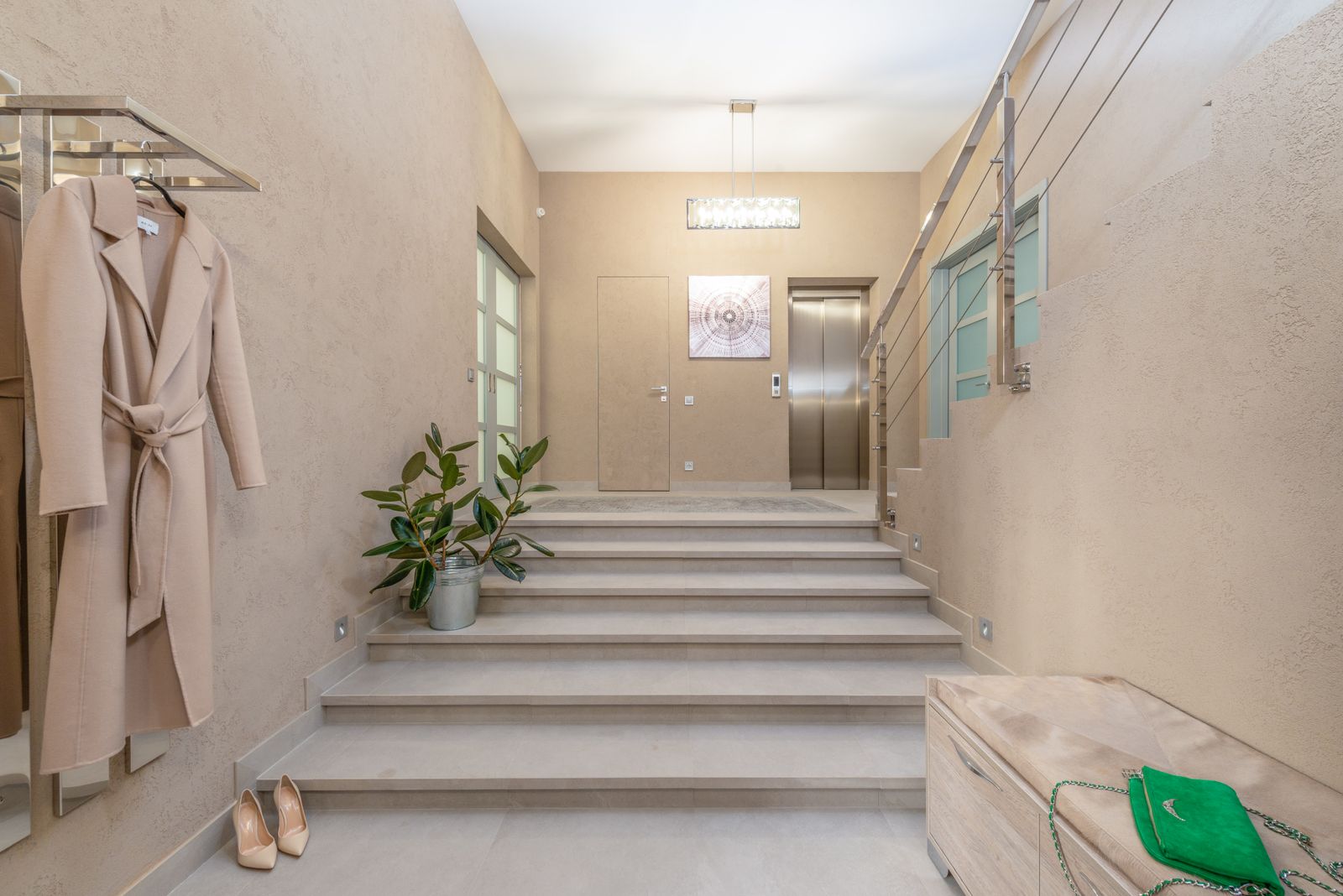 Apartment building lobby with an elevator and a wide staircase
